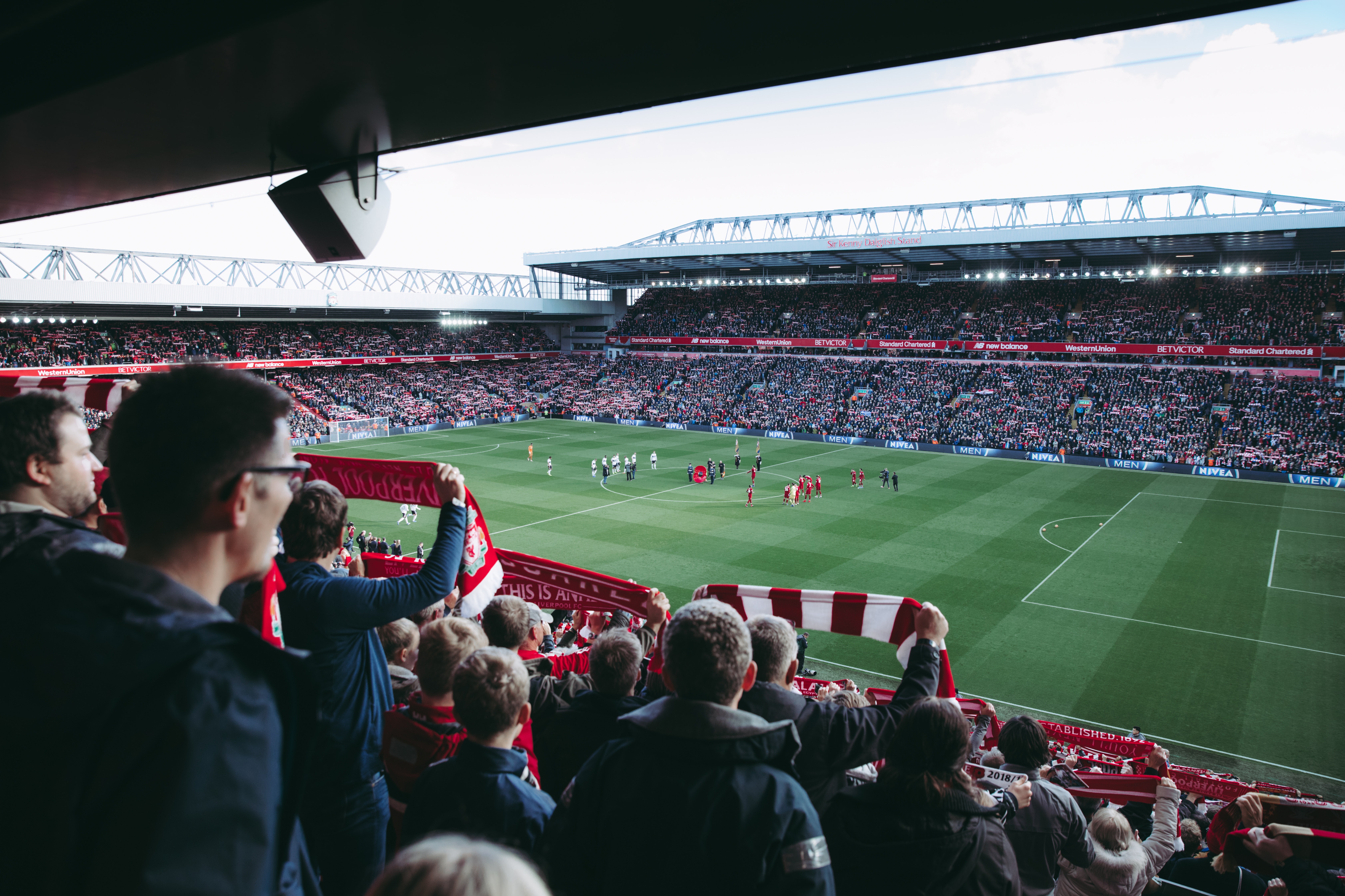 Soccer fans cheering in packed stadium